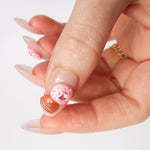 Reusable nail extensions doughnuts 3D art in long almond length.