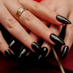 Black solid color Reusable nail extensions in long almond length. 