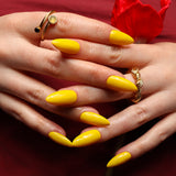 Yellow solid color Reusable nail extensions in long almond length. 