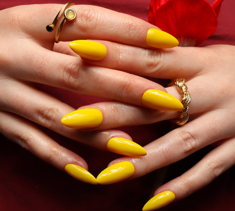 Yellow solid color Reusable nail extensions in long almond length. 