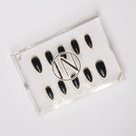 Black solid color Reusable nail extensions in long almond length. 