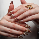 Reusable nail extensions abstract art in long round length.