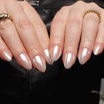 Reusable nail extensions in short almond length chrome nails. 