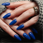 Blue solid color Reusable nail extensions in long almond length. 