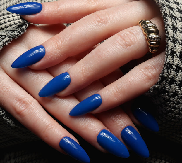 Blue solid color Reusable nail extensions in long almond length. 