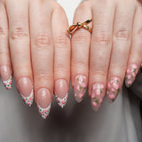 Floral Reusable nail extensions in long almond length. 