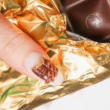 Reusable nail extensions chocolate 3D art in long almond length.