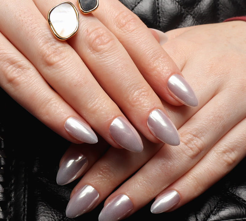 Reusable nail extensions in short almond length chrome nails. 