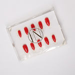 Red solid color Reusable nail extensions in long almond length. 