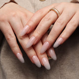 Reusable nail extensions clean manicure in long almond length.