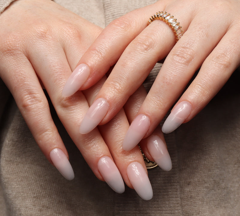 Reusable nail extensions clean manicure in long almond length.