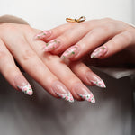 Floral Reusable nail extensions in long almond length. 