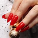 Red solid color Reusable nail extensions in long almond length. 