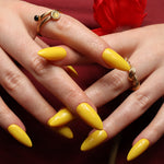 Yellow solid color Reusable nail extensions in long almond length. 