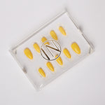 Yellow solid color Reusable nail extensions in long almond length. 