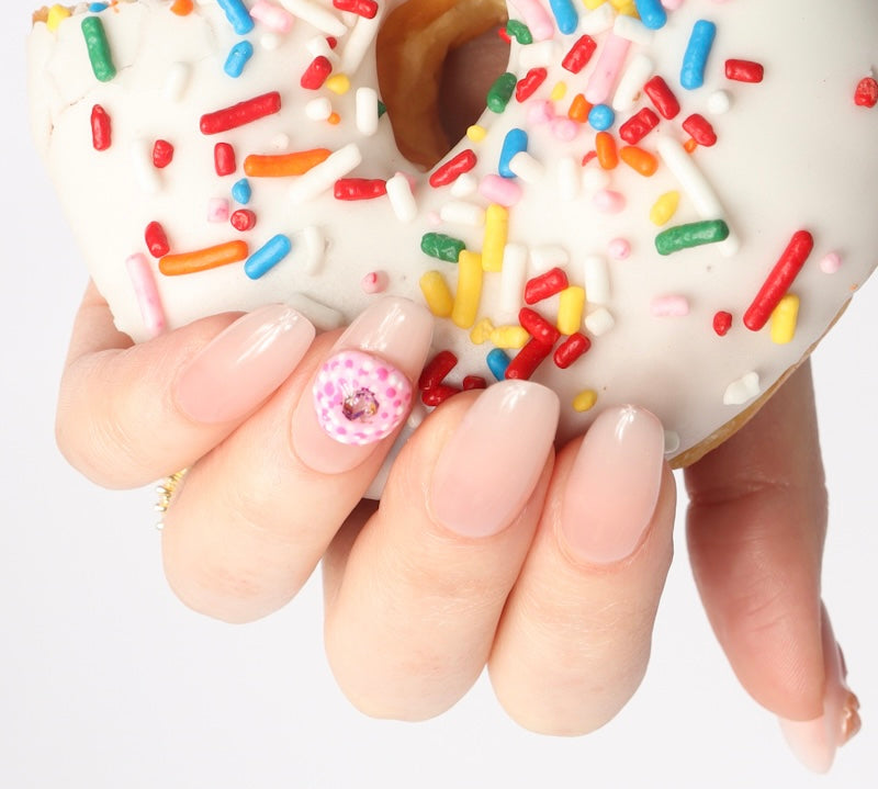 Reusable nail extensions doughnuts 3D art in long almond length.