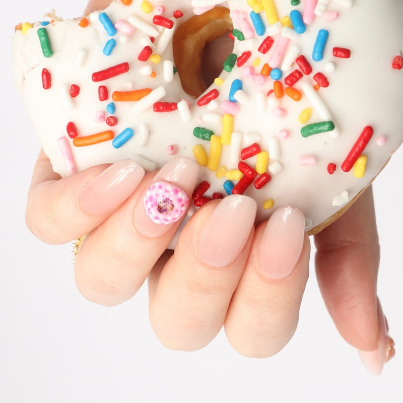 Reusable nail extensions doughnuts 3D art in long almond length.