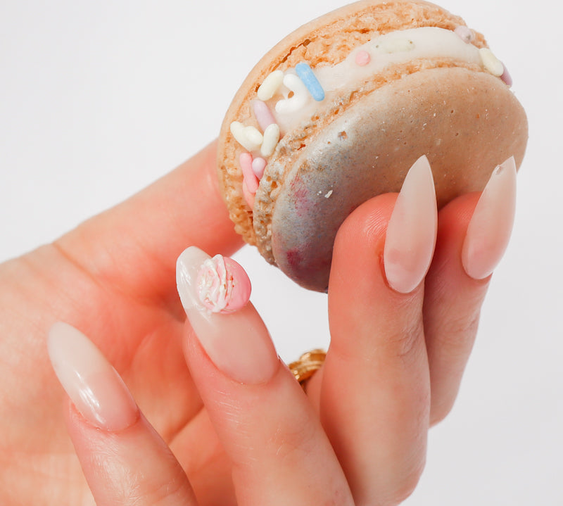 Reusable nail extensions macarons 3D art in long almond length.