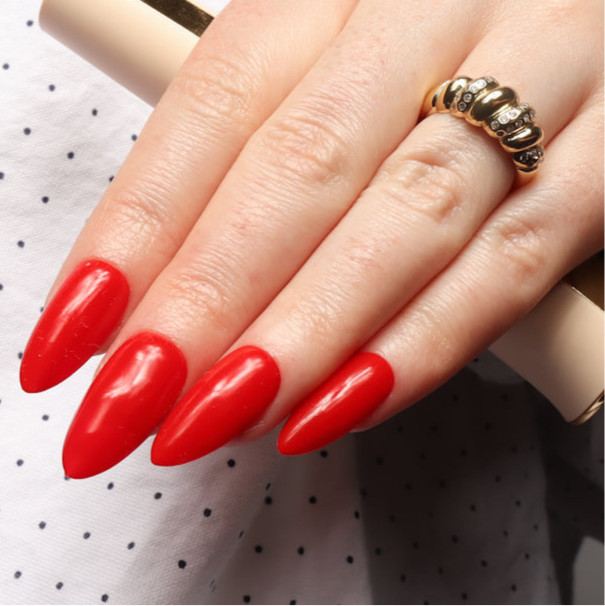 Red solid color Reusable nail extensions in long almond length. 