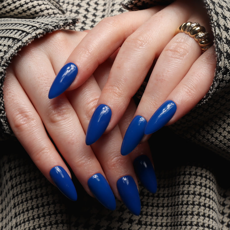 Blue solid color Reusable nail extensions in long almond length. 