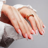 Reusable nail extensions in long almond length French nails. 