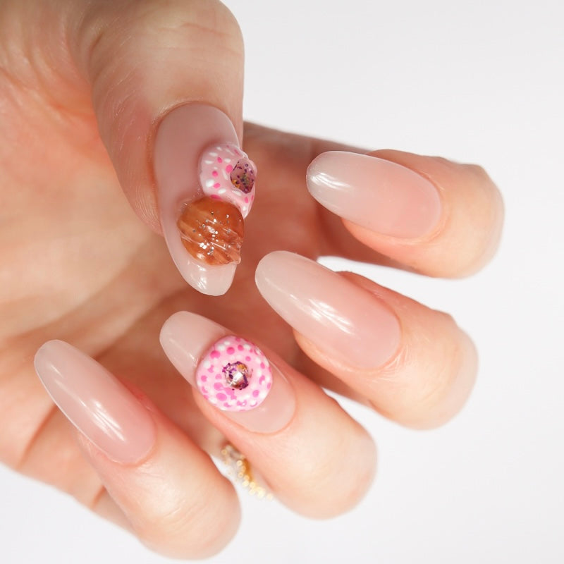 Reusable nail extensions doughnuts 3D art in long almond length.