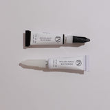 Two tubes of nail bond product on a light gray background