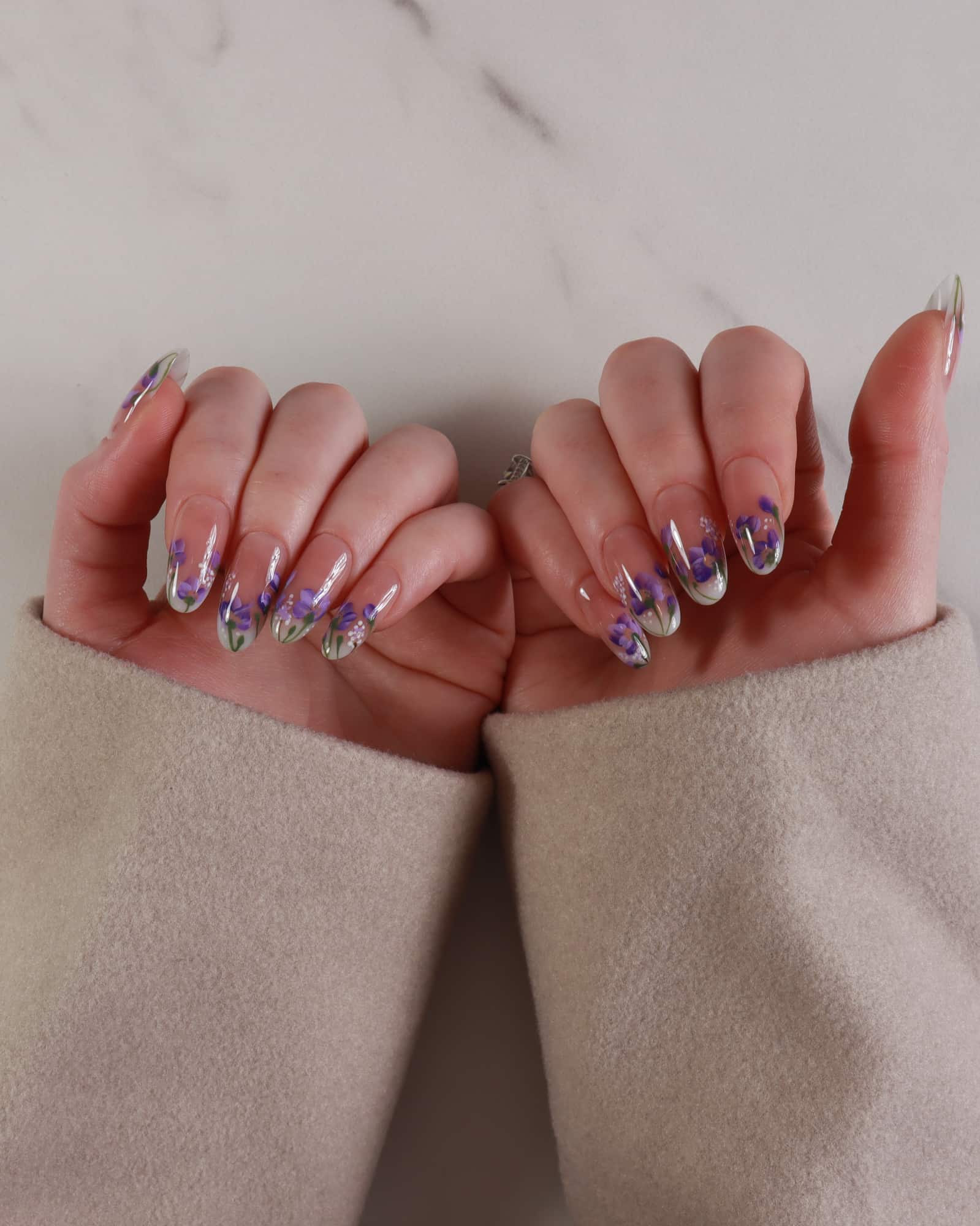 purple flowers nail extensions on hand