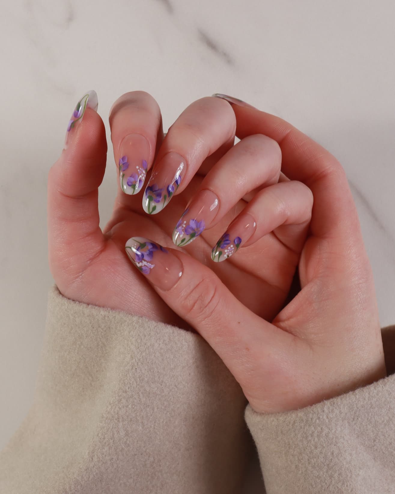 purple flowers nail extensions on hand
