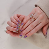purple flowers nail extensions on hand
