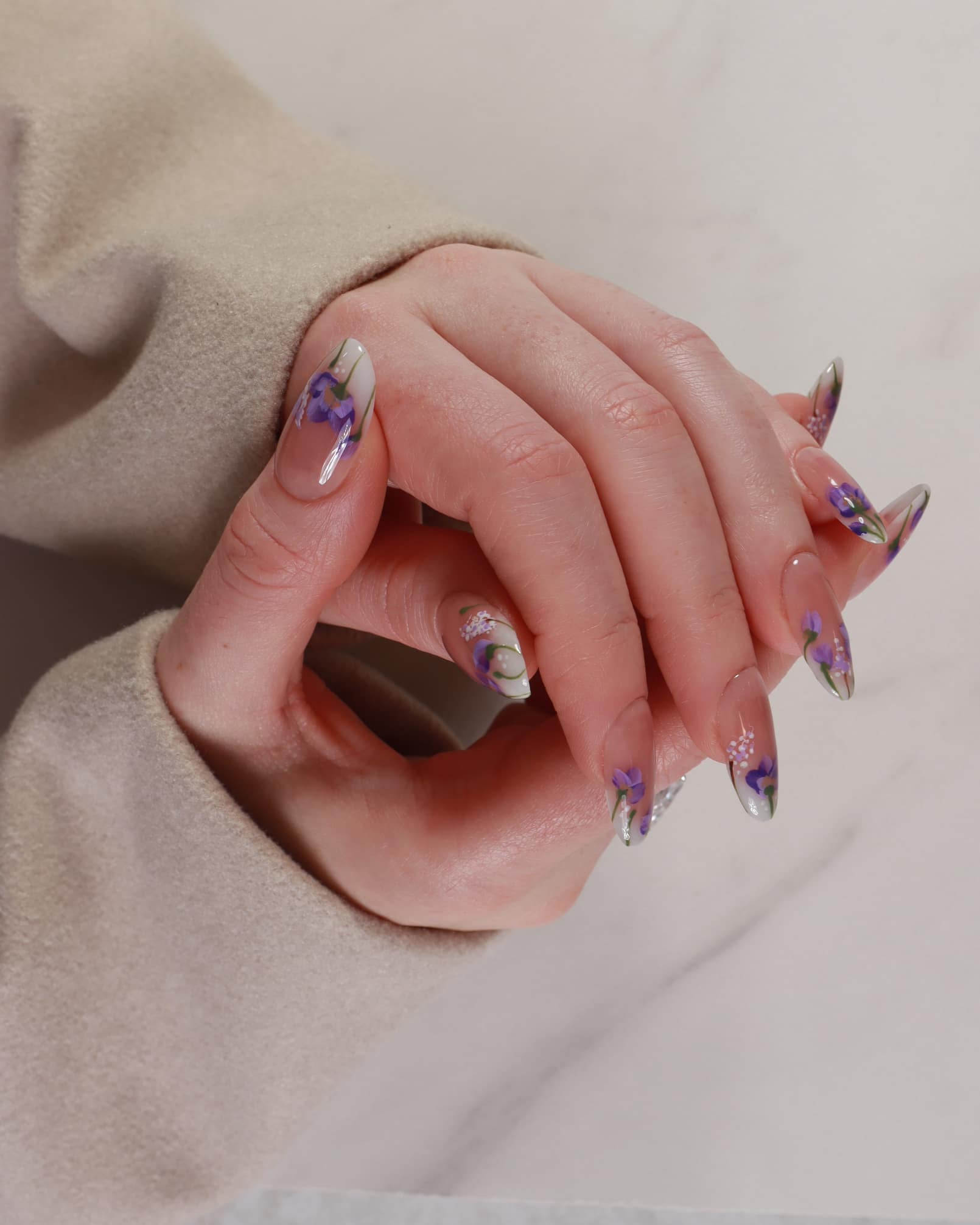 purple flowers nail extensions on hand