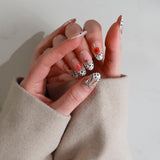 Hand with intricately designed nails held against a neutral background