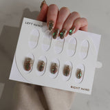 Nail art display with glittery nail designs on a neutral background