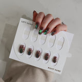 Nail art display with glittery nail designs on a neutral background