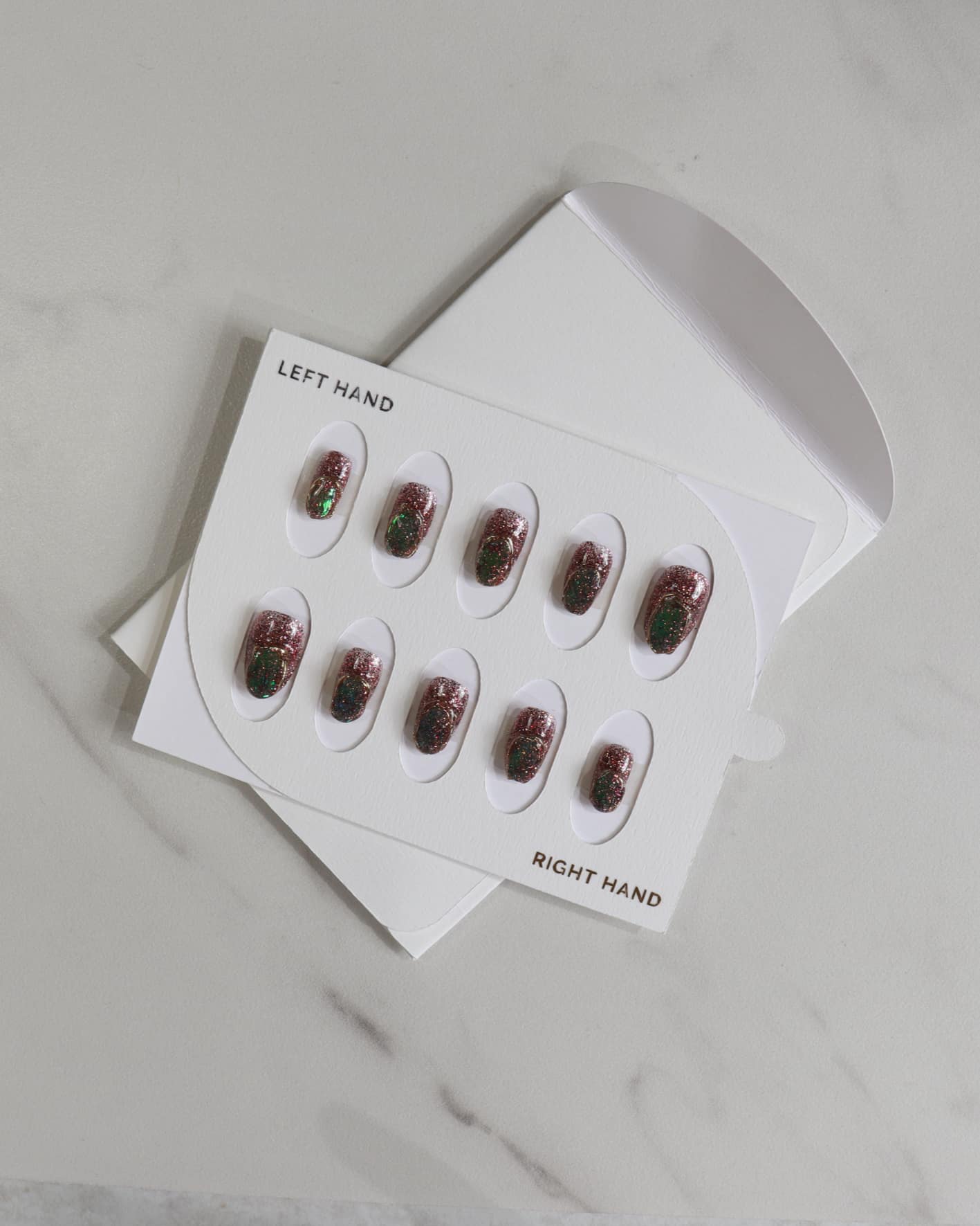 Nail art stickers in a white box on a light gray surface