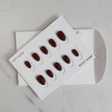 Set of red nail polish samples on a white background