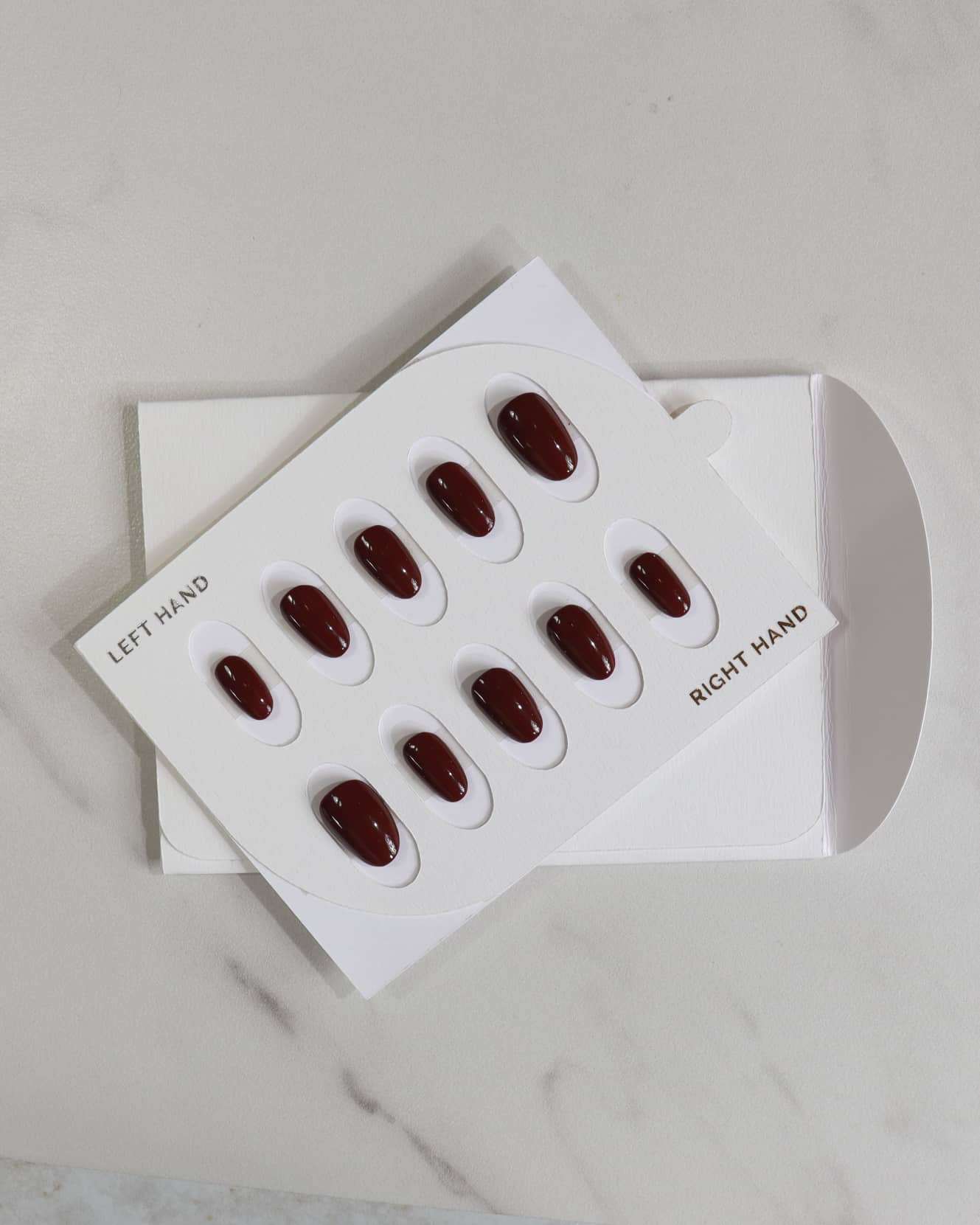 Set of red nail polish samples on a white background