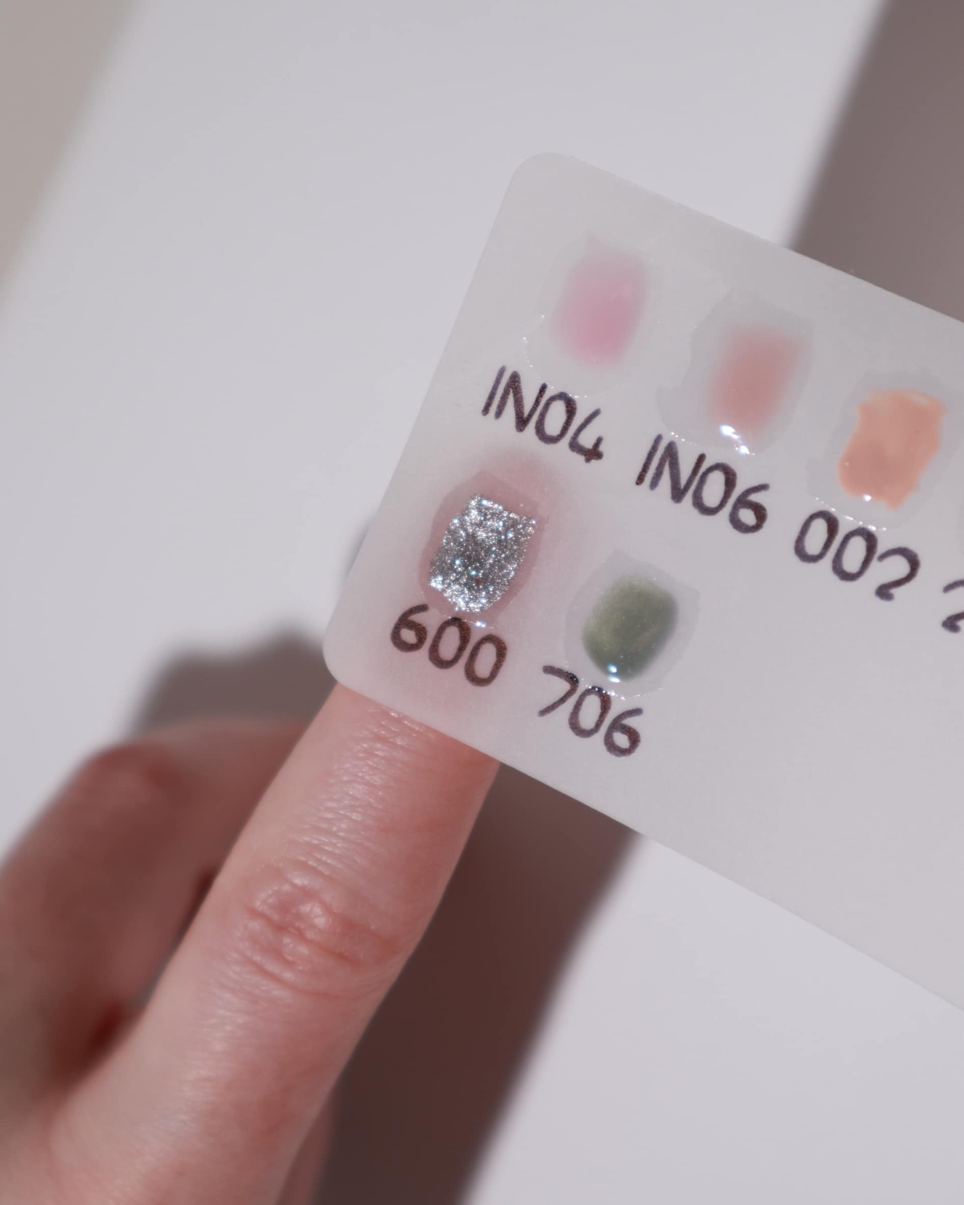 Color swatches in a white background  with a model hand