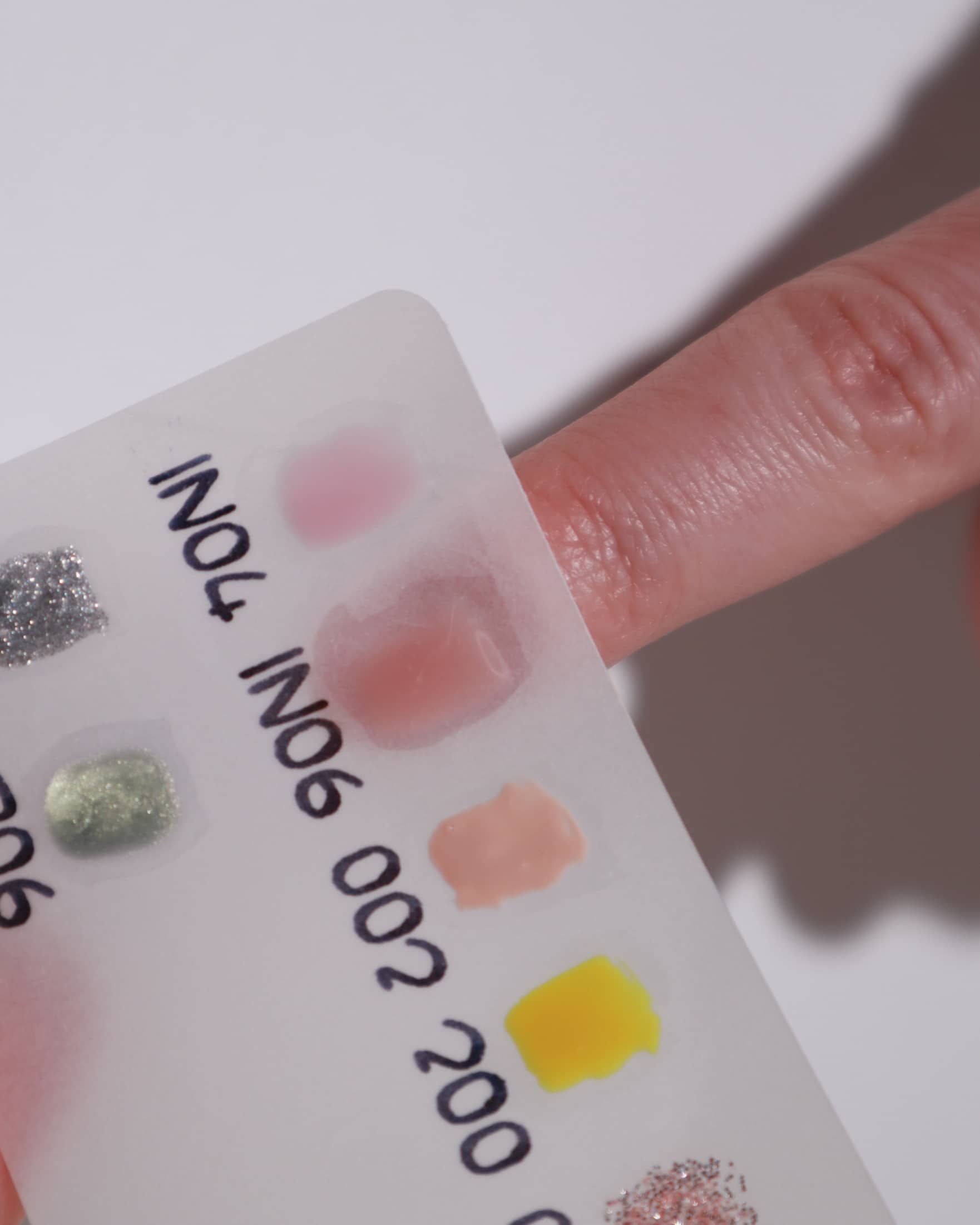 Color swatches in a white background  with a model hand
