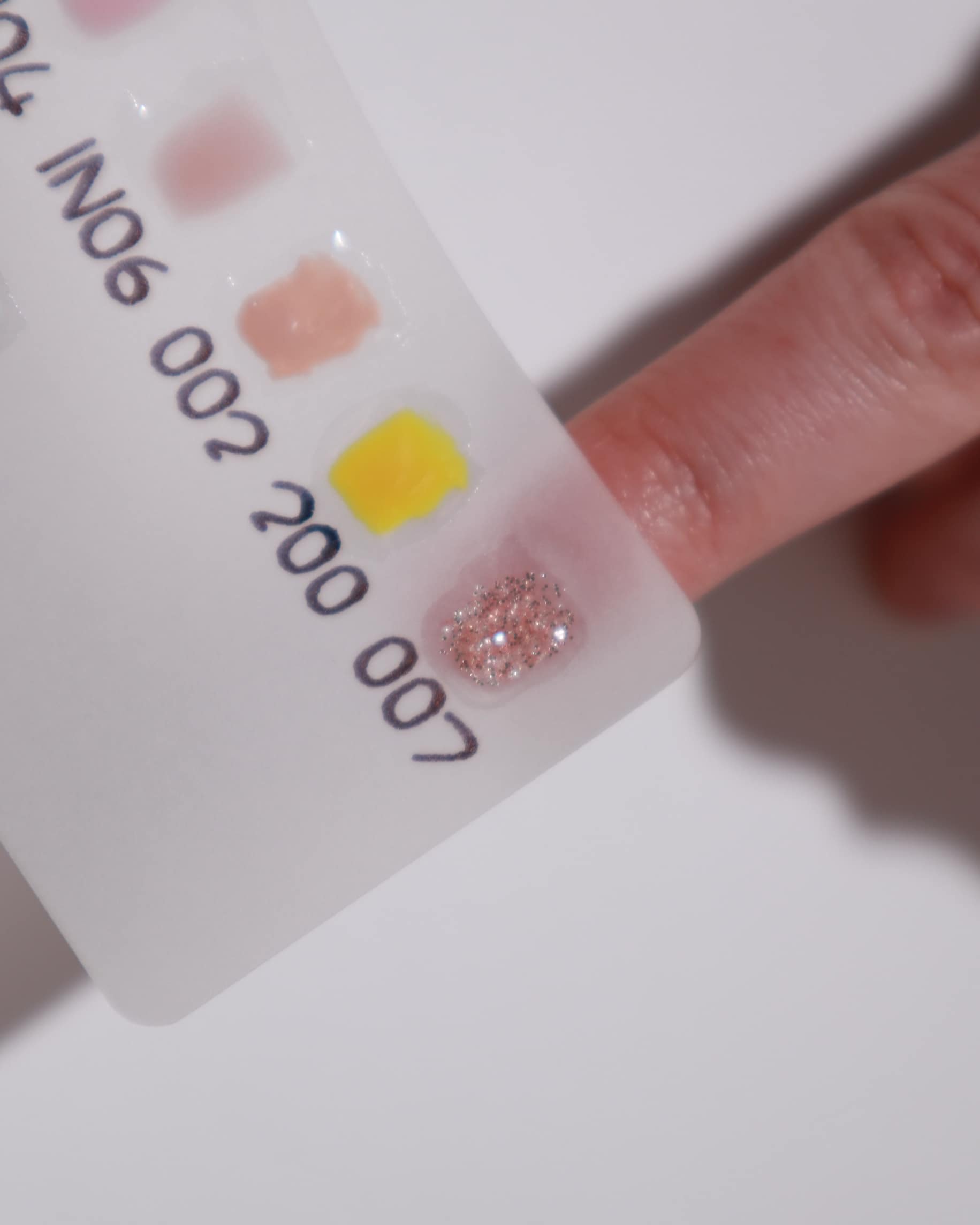 Color swatches in a white background  with a model hand