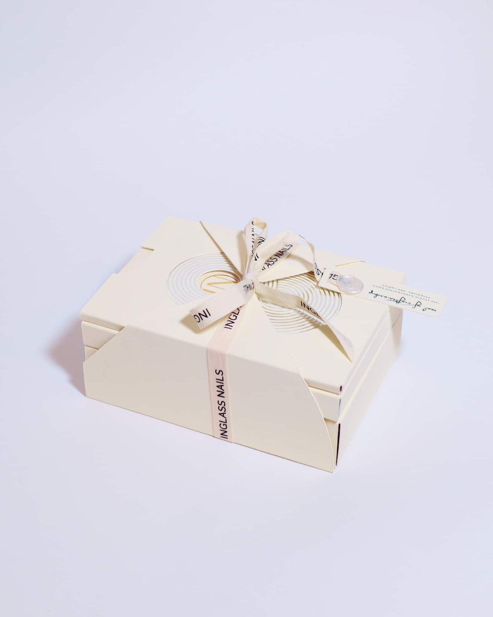 Nails box with a bow on a light background