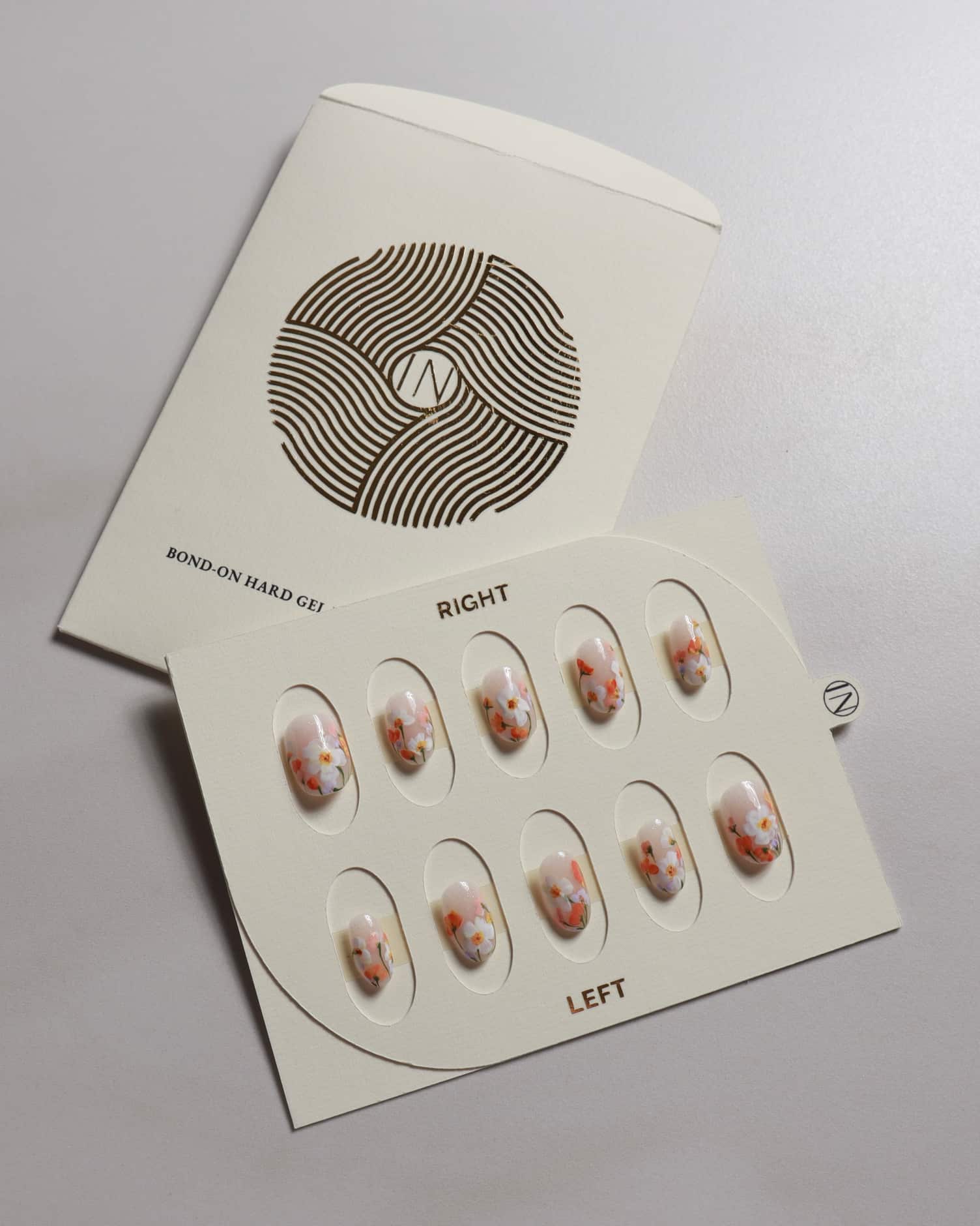 Nail art set display with packaging on a light gray background