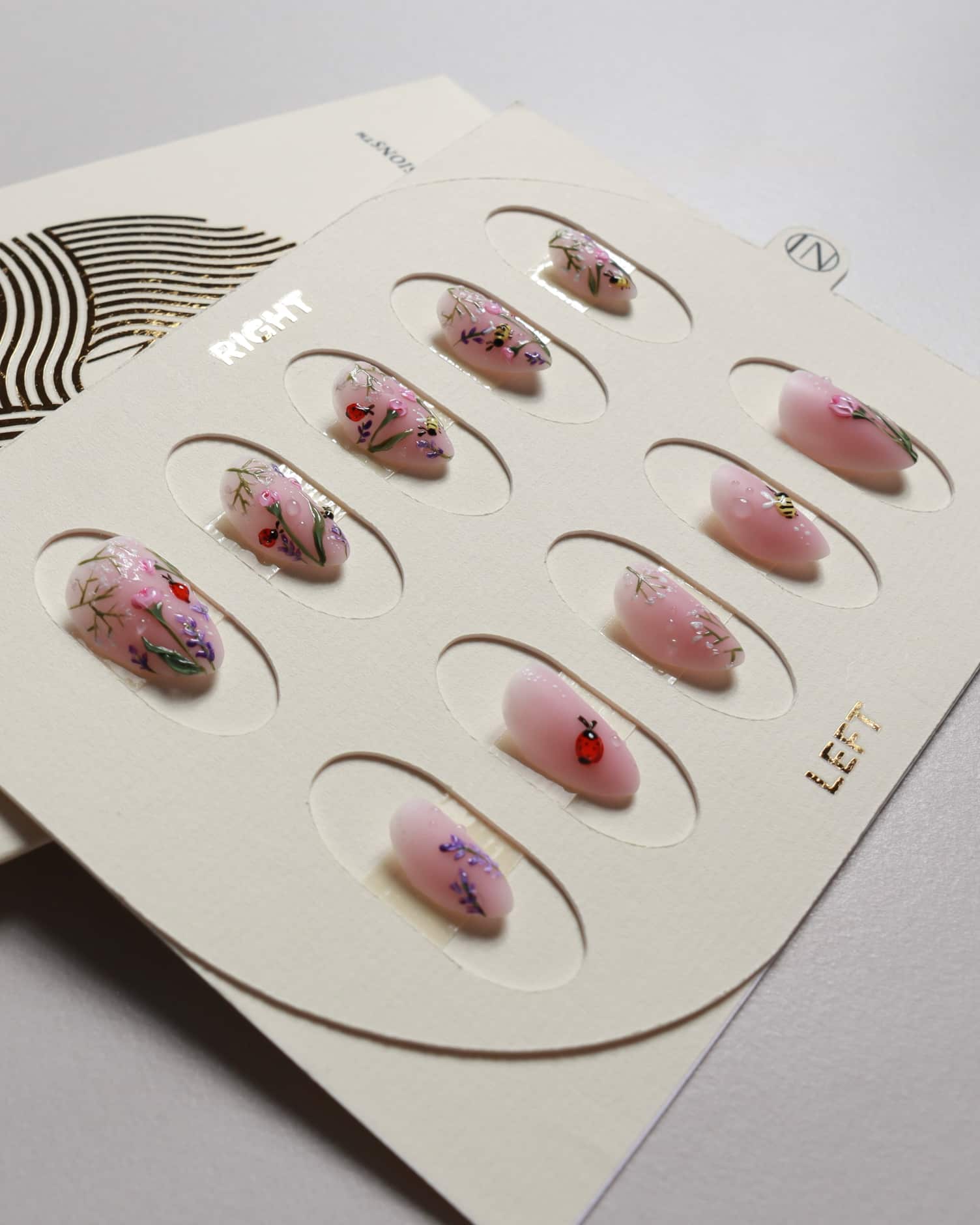 Nail set with floral designs on a white background