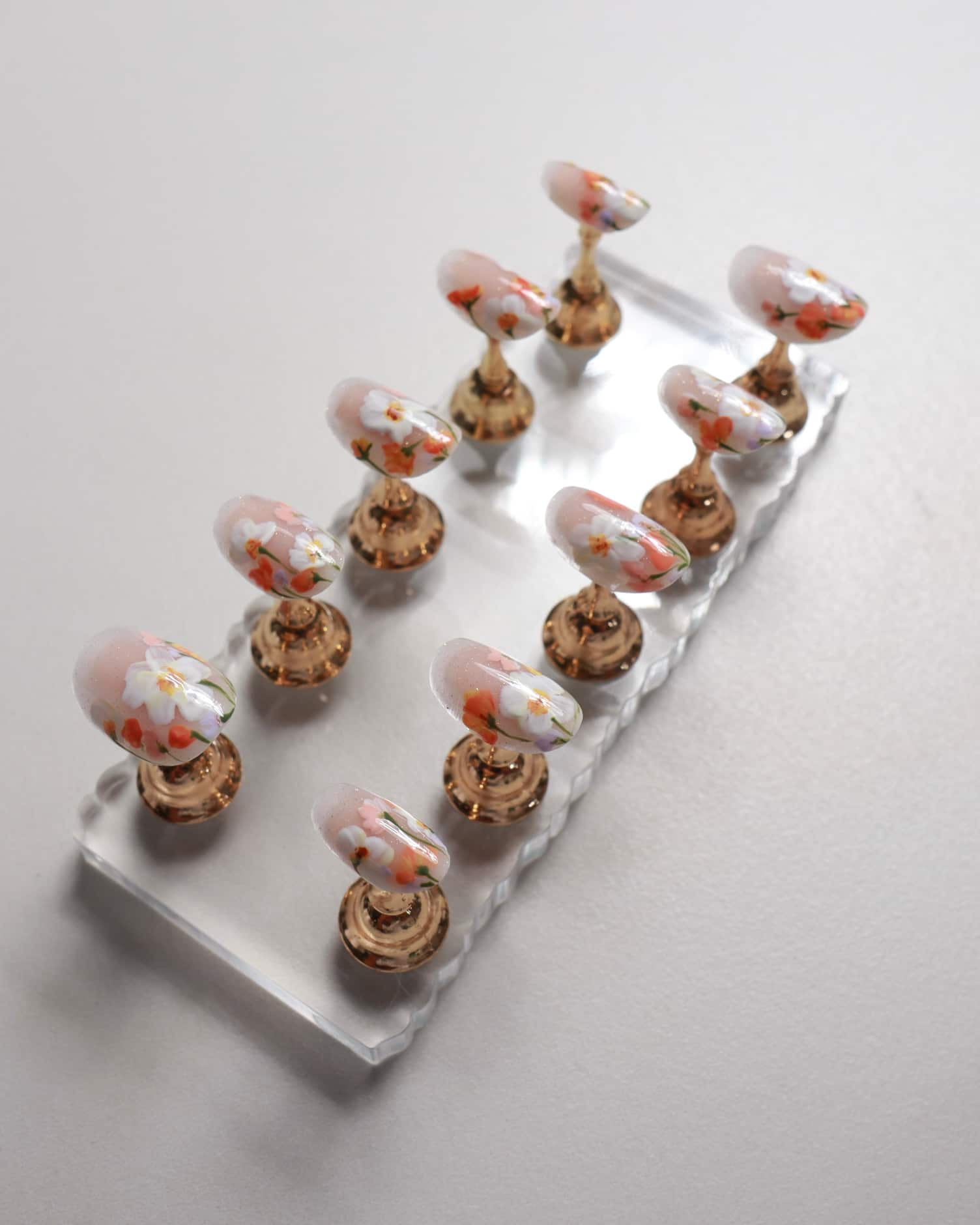 Set of decorative floral nails on a white background