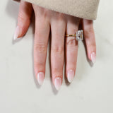 Close-up of a hand wearing two rings on a light background