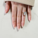 Hand wearing a diamond ring on a light background