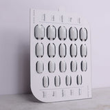 Nail art display board with cut-out shapes for nails on a light gray background