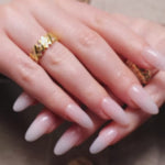 Reusable nail extensions clean manicure in long almond length.