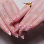 Floral Reusable nail extensions in long almond length. 