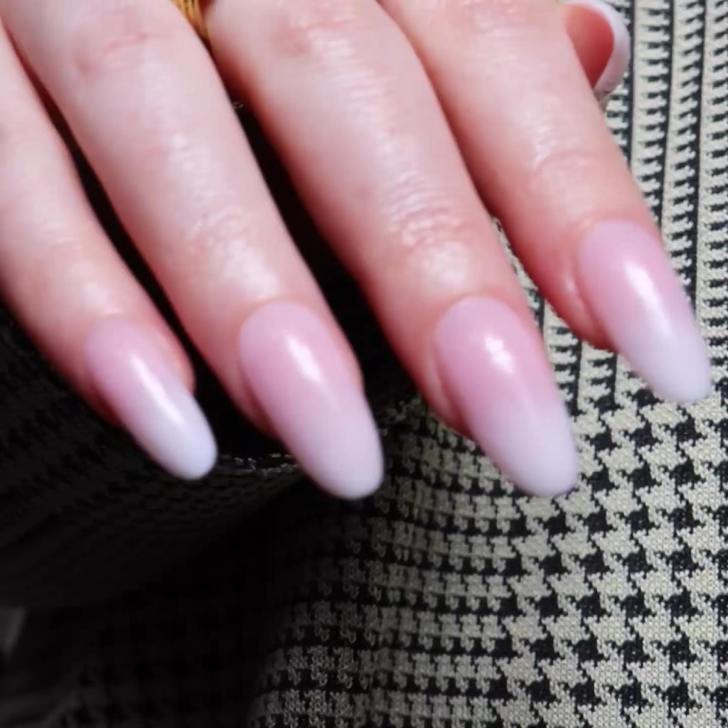 Reusable nail extensions in long round length ombre nails. 